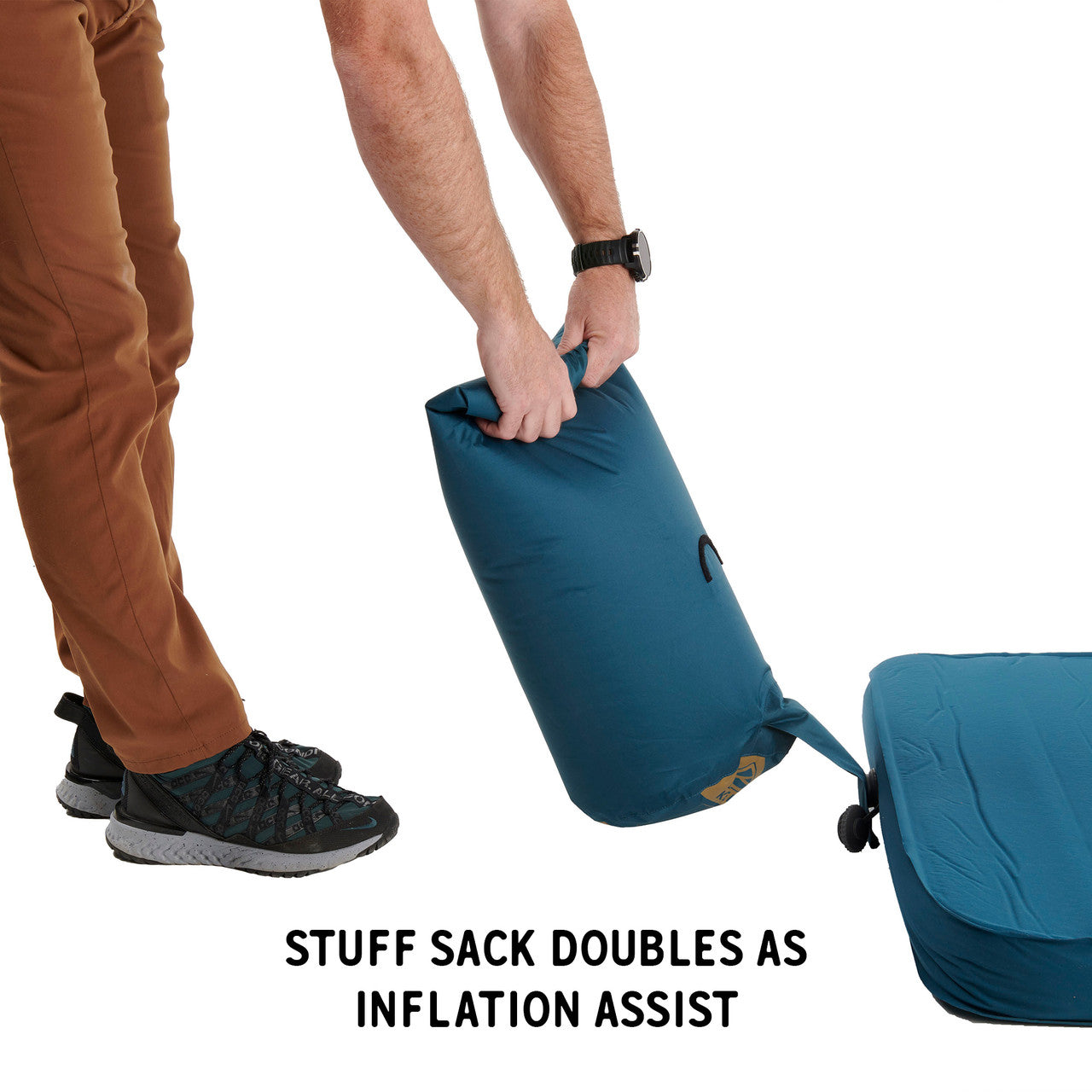 Man inflating Kelty Waypoint Si Sleeping Pad with inflation bag