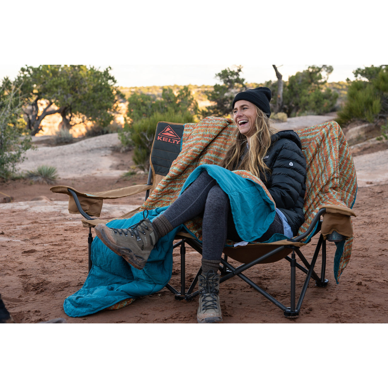 Camper with Kelty Biggie Blanket, sitting in chair