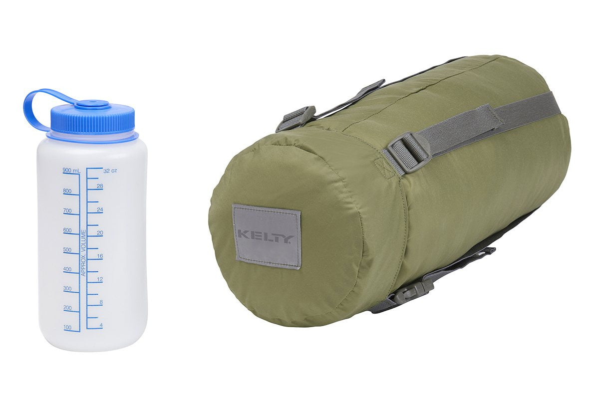 Kelty Varicom Compression Sack. shown next to 32 oz. water bottle