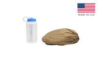 Kelty VariCom No Fly Zone USA bivy, shown packed inside of storage bag, bag lying flat next to 32 oz. water bottle