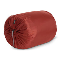 Kelty Mistral 0 sleeping bag, shown packed inside orange stuff sack